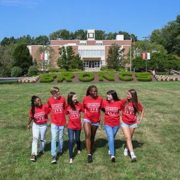 Students on campus mall in front of library