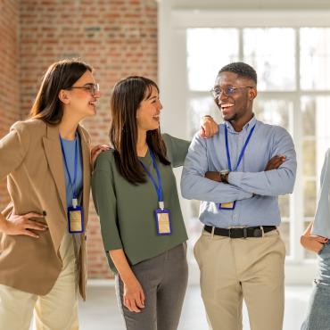 colleagues discussing and laughing in a group