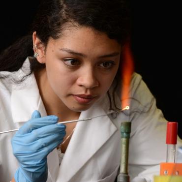 McNair student performs experiment in a lab.