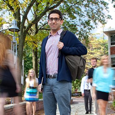 Graduate student standing on way to class.