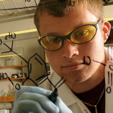 Image of student in lab, Explore majors and success stories.