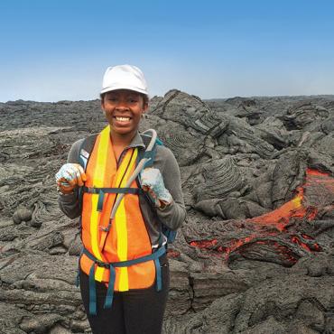 Imani Guest stands on volcanic rock.