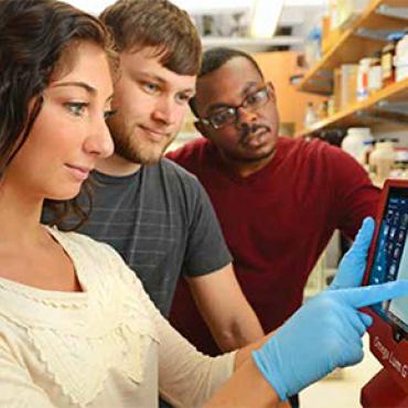 Students gathering in a lab.