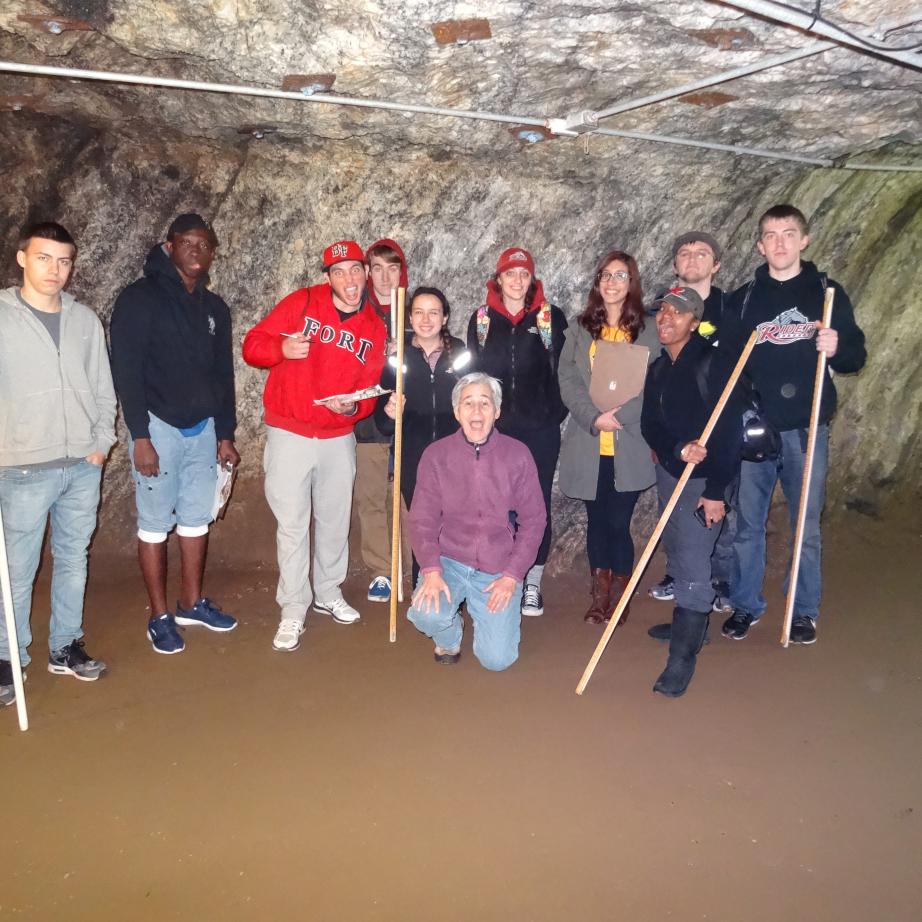 students and faculty in an underground cave