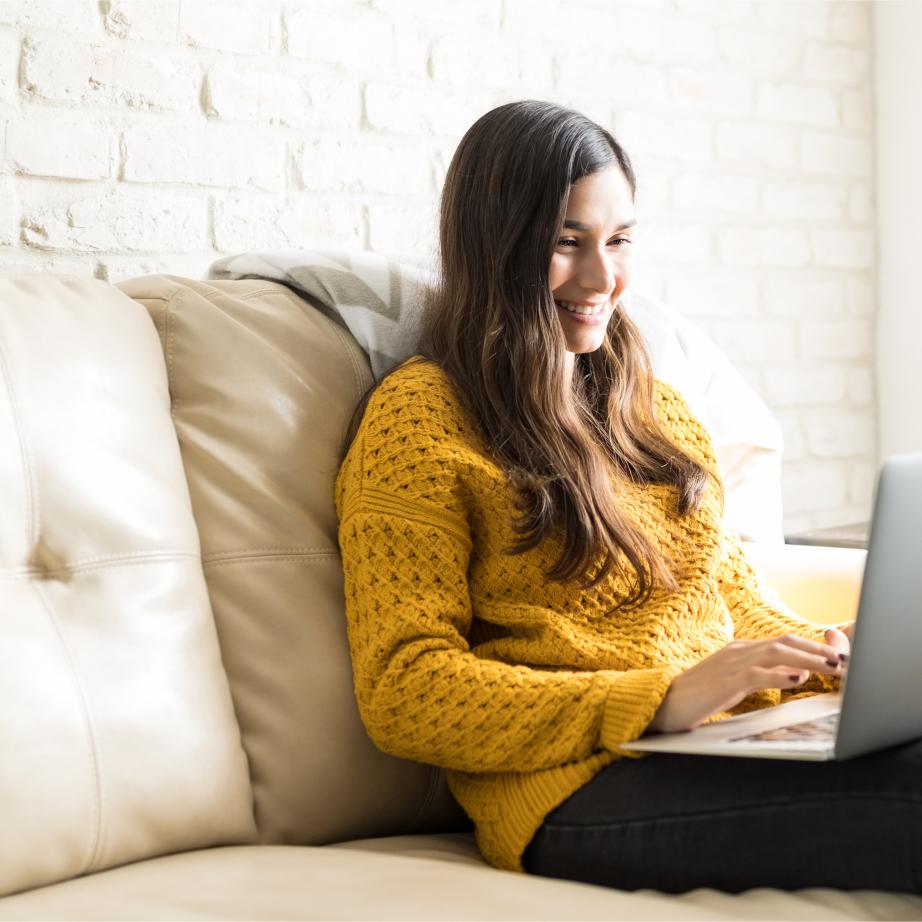 Student in yellow sweater takes an online course