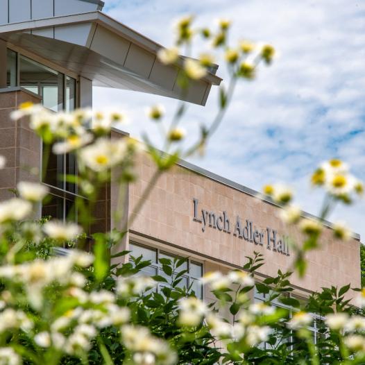 Lynch Adler Hall with flowers.