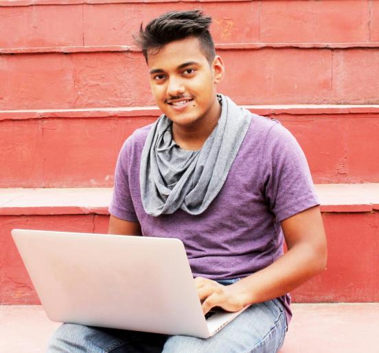 Young man sitting with his laptop